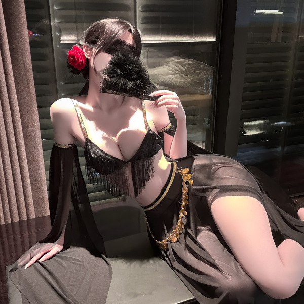 Woman in black luxury sensual lingerie set with gold trim, sheer robe, and feather fan. elegant exotic boudoir wear.