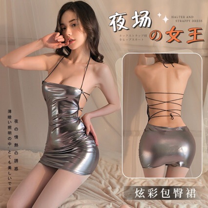 Woman modeling a shiny silver backless halter sleepwear set with crisscross straps and a form-fitting club skirt.
