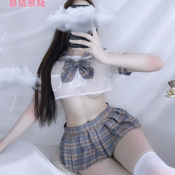Woman modeling a plaid sailor-style two-piece outfit featuring a sheer crop top with a bowknot and a matching short skirt.