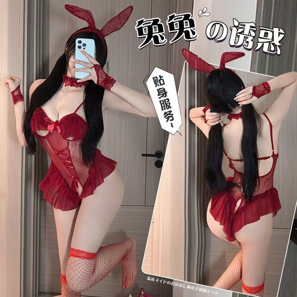 Woman modeling a red sexy bunny costume for women, featuring lace lingerie, fishnet stockings, and bunny ears, perfect for da...