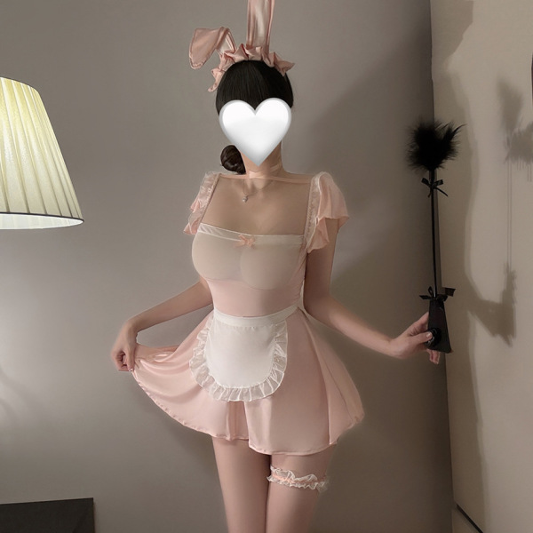 Woman wearing pink lace sheer bunny maid costume with apron, garter, and ears for role play lingerie.