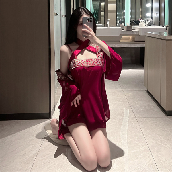 Woman kneeling in bathroom wearing red sheer mesh cheongsam lingerie set with vintage bodice and matching outer jacket.