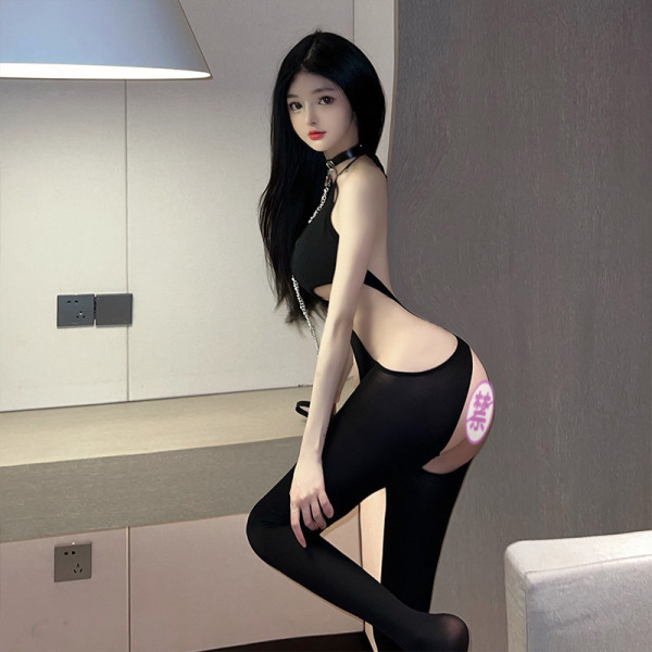 Woman modeling sexy -style bodysuit set with sheer mesh top, open-crotch tights & halter neck design in modern room.