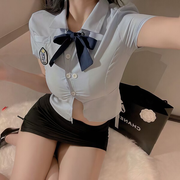 Sexy female police officer costume with tight shirt, bow tie, and mini skirt for role play, cosplay, or themed events.