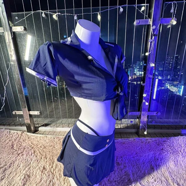 Sexy flight attendant costume set displayed on mannequin, featuring a navy blue cropped top and matching skirt with white acc...