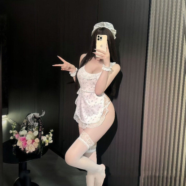 Woman posing in sexy lace backless maid costume with sheer apron sleep dress, bare-back design and cheeky cutout detail.