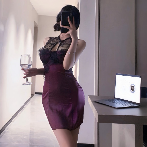 Woman in sexy lace bodycon mini dress with built-in pads, holding wine glass, taking mirror selfie.