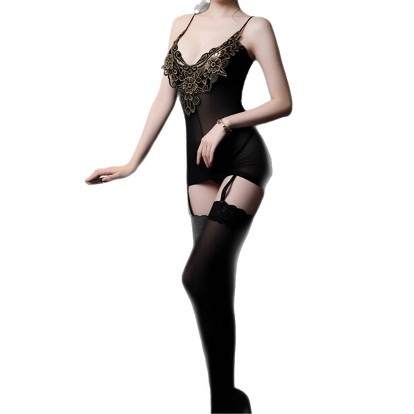 Woman wearing black lace bodysuit with sheer mesh, attached skirt, and matching stockings – elegant seductive lingerie set.
