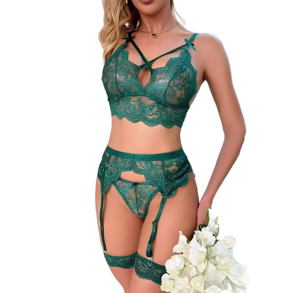 Woman wearing a sexy green lace lingerie set with sheer bra, panty, and garter straps.
