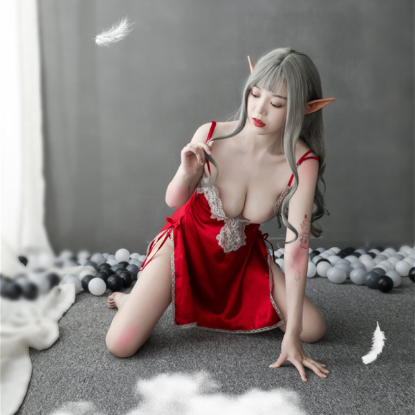 Woman in red lace open-front chemise and matching robe, kneeling on floor with gray balls and floating feathers.