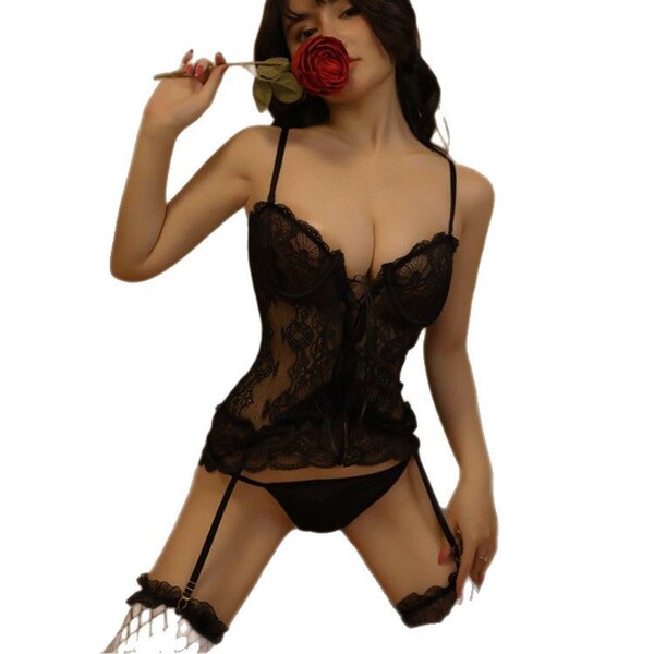 Woman in black lace babydoll bodysuit with garters, holding a red rose.