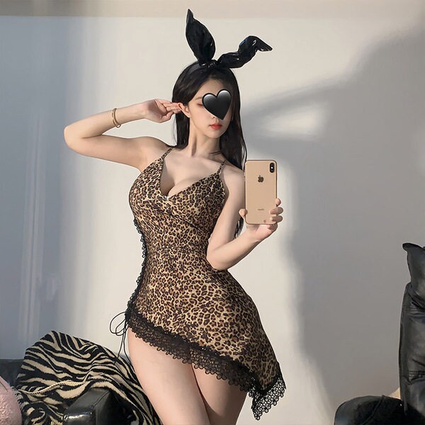 Woman in sexy leopard print lingerie set with bunny ears, taking a mirror selfie.