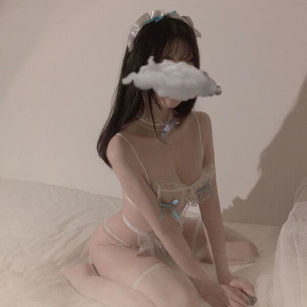 Woman wearing sexy maid costume with lace sheer corset, ties, and bow—role play lingerie outfit for women.