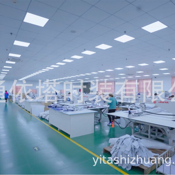 Factory interior showcasing sewing operations with watermark, featuring production environment for womens skirts.
