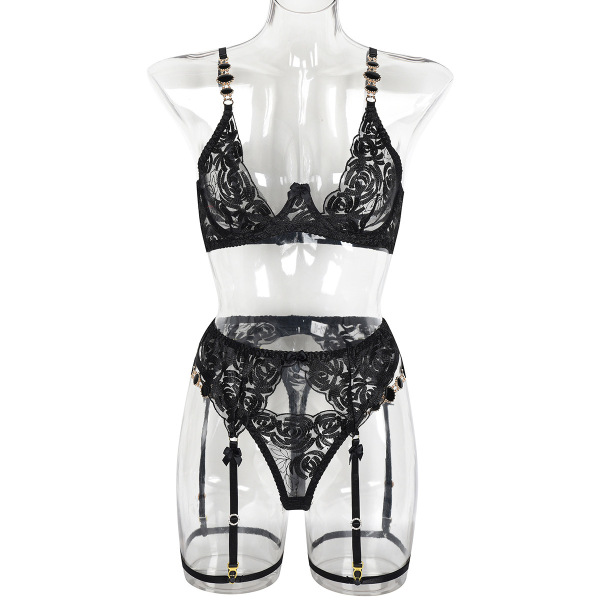 Black lace lingerie set with floral embroidery and garter straps on mannequin.