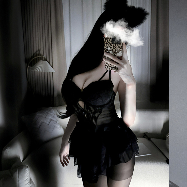 Woman wearing black lace cami dress with built-in pads, part of sexy nightclub sleepwear set with matching lingerie.