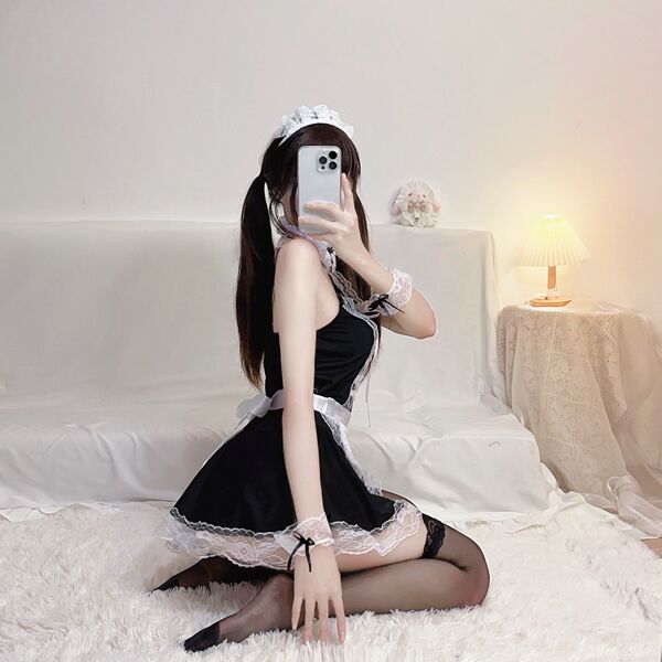 Woman in black plus size maid costume with lace trim, posing on white rug. seductive lingerie sleepwear outfit for women.