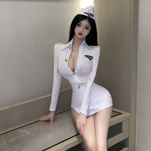 Woman in white sexy police cosplay costume with flight attendant hat, featuring a deep v-neck and gold buttons.