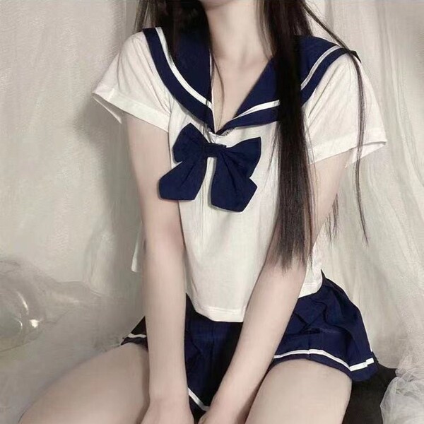 Sexy sailor schoolgirl lingerie set featuring a sailor-style top with a bow tie and matching skirt, perfect for nightclub out...