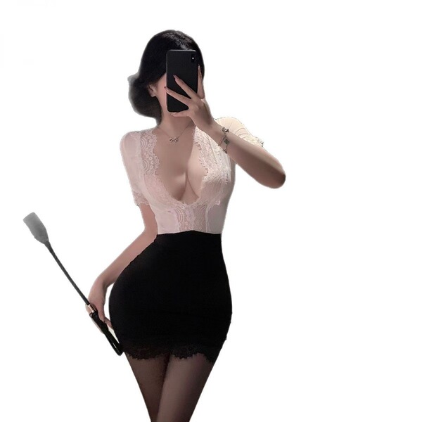 Woman in sexy secretary pencil skirt set with lace top, black mini skirt, and sheer stockings holding a paddle.