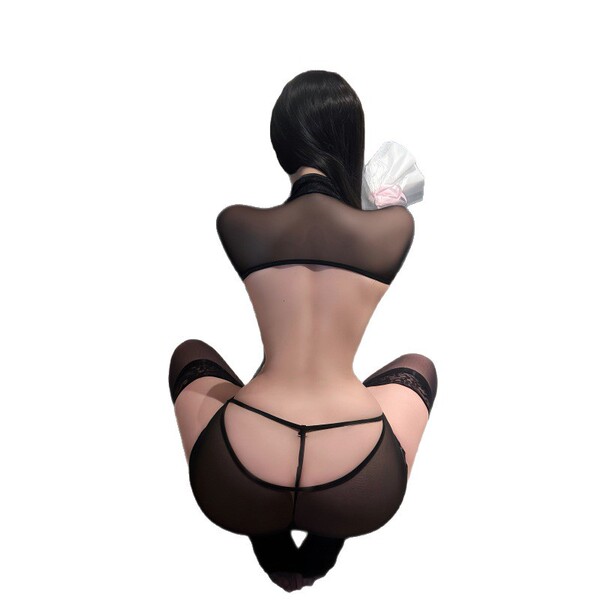 Woman wearing black sheer cheongsam lingerie set with lace trim and adjustable tie detail, viewed from behind.