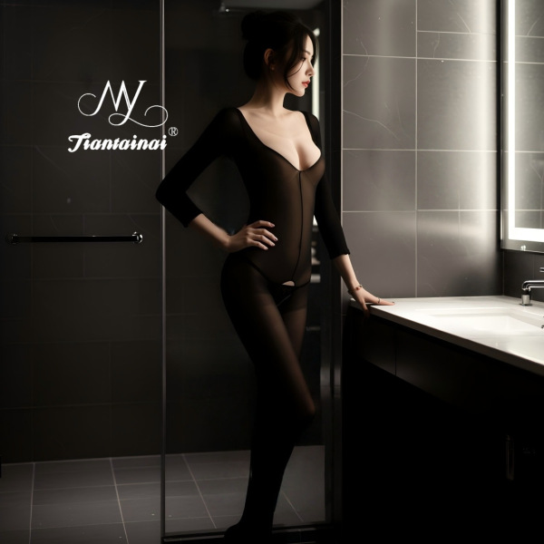 Woman wearing a sexy sheer open-crotch bodysuit in a modern bathroom, showcasing the transparent lingerie outfit’s seductive ...