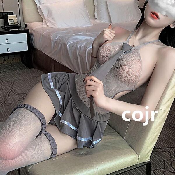 Woman in sexy student jk uniform set with lace bodysuit and sheer stockings, posing seductively on a chair.