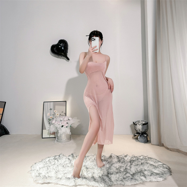 A woman poses in a sheer lace cami dress, featuring a side slit and romantic mesh design, perfect for a sexy transparent slee...