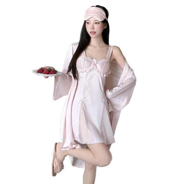 A woman wears a silk-inspired sleep dress featuring a built-in padded strap and backless design, holding strawberries while p...