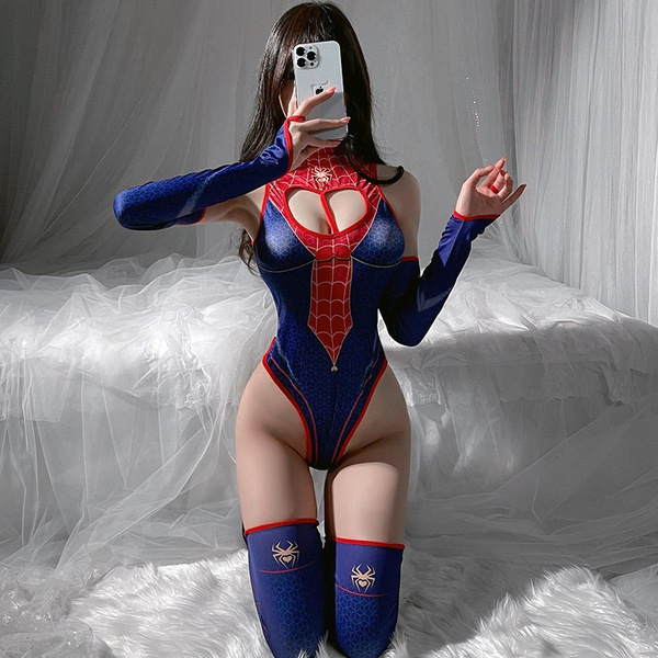 Woman in spider-man cosplay bodysuit with open-crotch design, posing on a bed with white drapes.