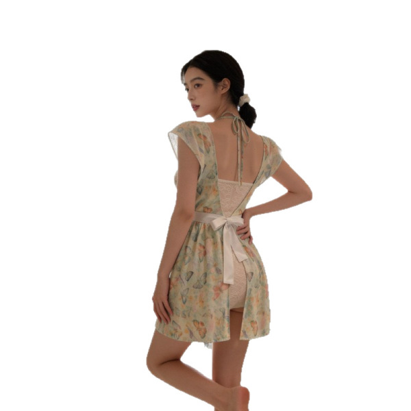 Woman wearing su shi floral lingerie dress with deep v back, sheer mesh, and bow tie - sexy nightwear.