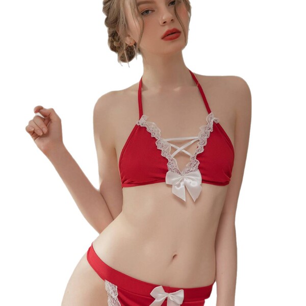 Woman wearing red sultry sheer -style strapless lingerie set with white lace trim and bow details.