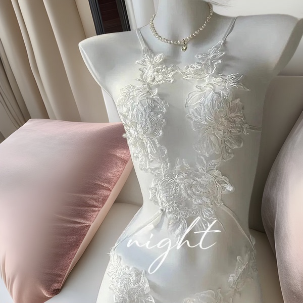 White sheer lace bodysuit with floral embroidery on mannequin.