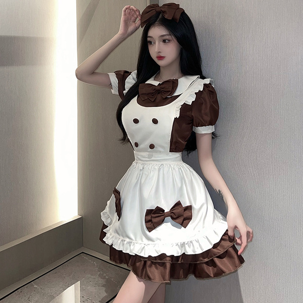A woman poses wearing a maid-themed dress, featuring a cream and brown color scheme with ruffles and bows, perfect for anime ...