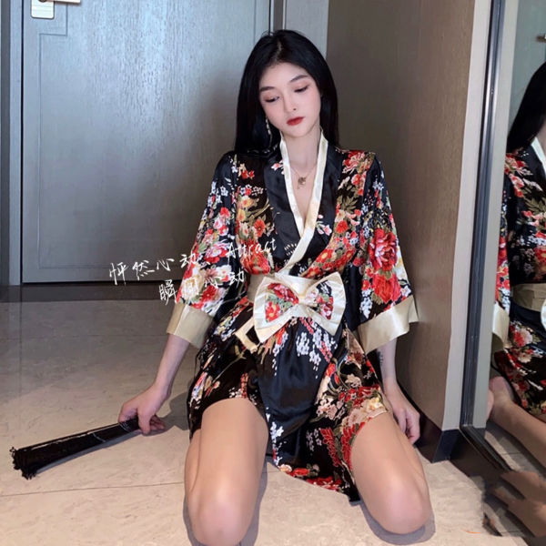 Woman wearing a black floral suoqing japanese-style sexy lingerie kimono robe with a low-cut design and bow belt, posing indo...