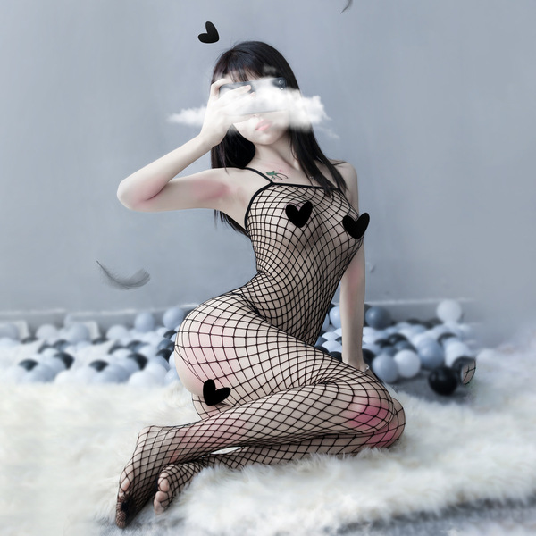 Woman wearing suoqing sensual mesh bodysuit, a sexy tight-fit sheer lace outfit with large-weave design, posing on fluffy rug...