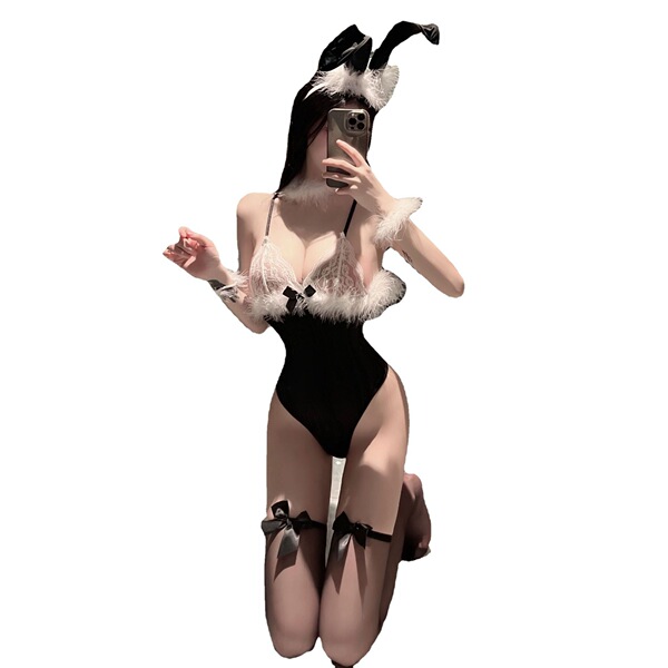 Woman in black suoqing sexy catgirl maid costume with white fur trim, bunny ears, and thigh garters, kneeling while taking a ...
