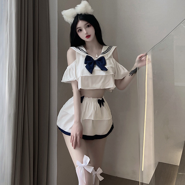 A stylish outfit featuring a sailor-themed top with ruffled sleeves and a large bow, paired with a pleated mini skirt and mat...