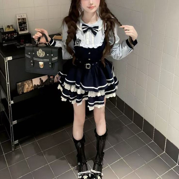 A stylish woman wears a sweet lace doll collar bow dress featuring an american preppy style. the dress has a spring/fall a-li...