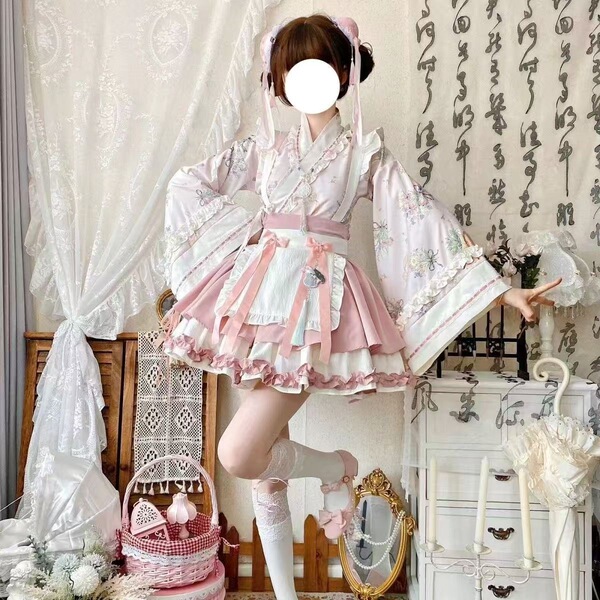 A woman poses in a sweet lolita maid dress set, featuring a floral-patterned kimono with ruffles and a matching apron. the ou...