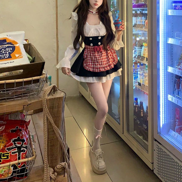 A woman models a sweet maid outfit featuring a plaid apron dress with a bow and waist cinching petticoat, perfect for spring ...