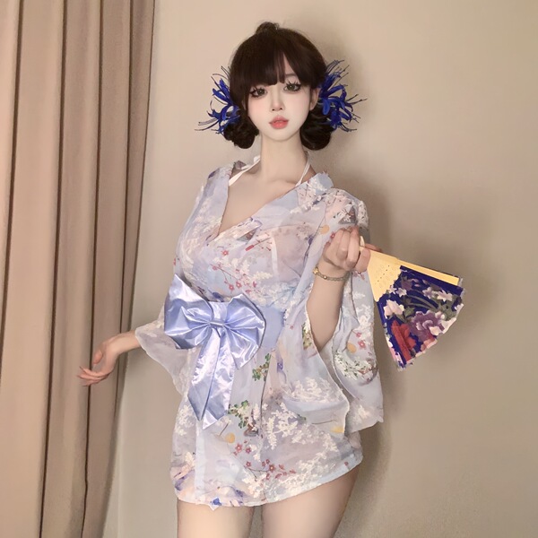 A woman poses elegantly in a sweet & seductive yukata robe featuring floral prints, satin trim, and a bow detail, perfect for...