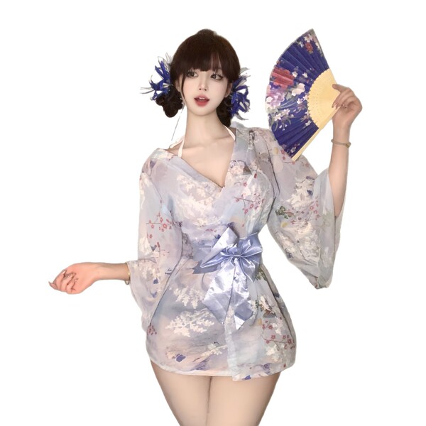A woman models a sweet & seductive yukata robe featuring floral prints, satin trim, and bow detail, perfect for cosplay or ba...