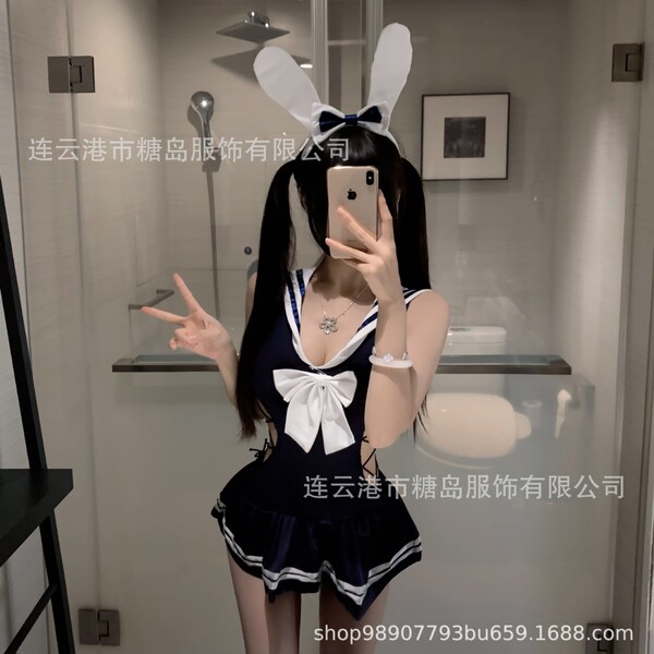 Woman in navy sailor-style lingerie with white bow and bunny ears, taking a mirror selfie. tangdao sensual lingerie set for w...