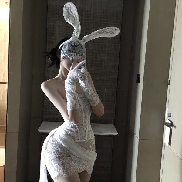 Woman in taoxitang sexy lingerie set with sheer lace sleep dress, bunny ears, and gloves posing seductively.