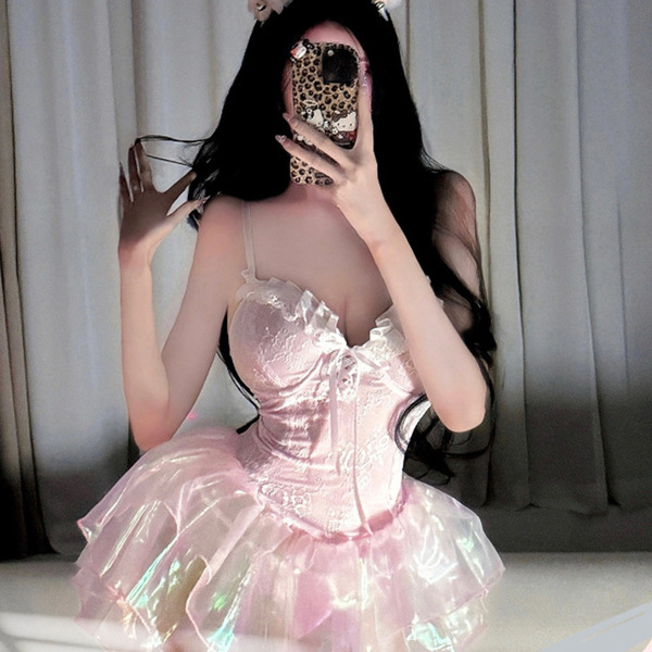 A woman poses with a leopard phone case, wearing a shimmering pink corset dress paired with a voluminous tutu skirt. the outf...