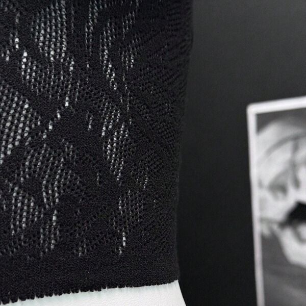 Close-up of black twill lace fabric detail on the twill lace seductive bare-butt lingerie top, highlighting intricate pattern...