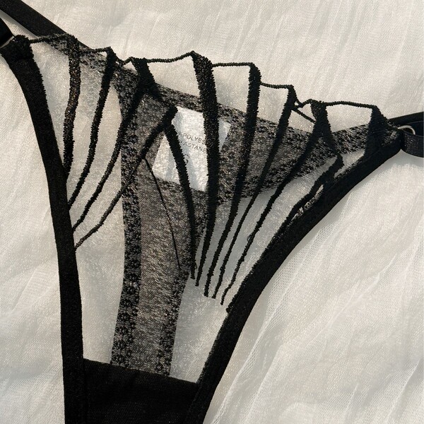 Ultra-thin sheer lace lingerie set with sensual black detailing and elegant straps, perfect for temptation and desire.