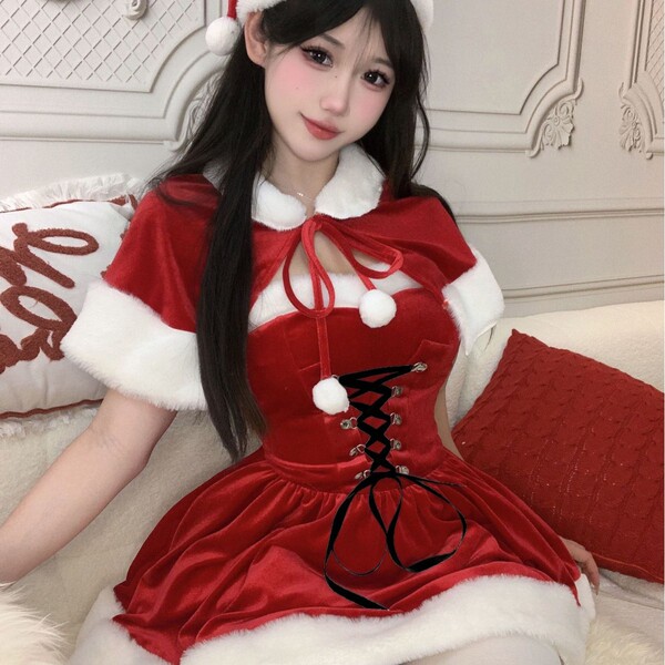 A festive santa-themed dress featuring a velvet sweet mood design, complete with a waist cinching cape and pom-pom accents, p...