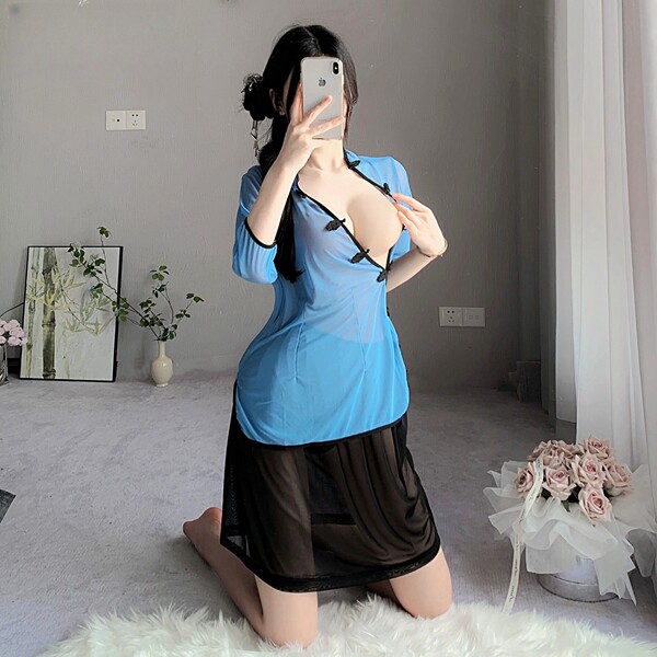 Woman kneeling in blue sheer vintage chinese-inspired lingerie set with side slit, retro qipao style sensual outfit.